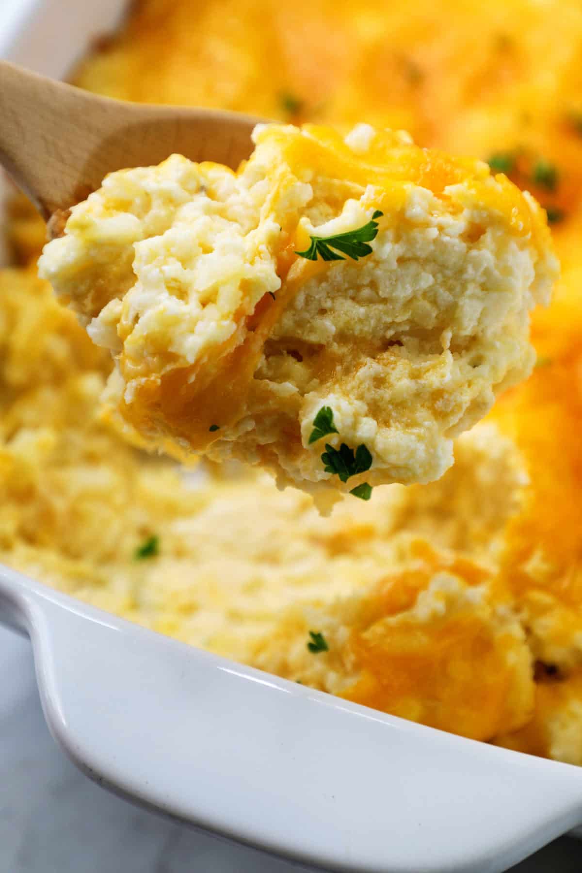 close up of hashbrown casserole topped with cheese 