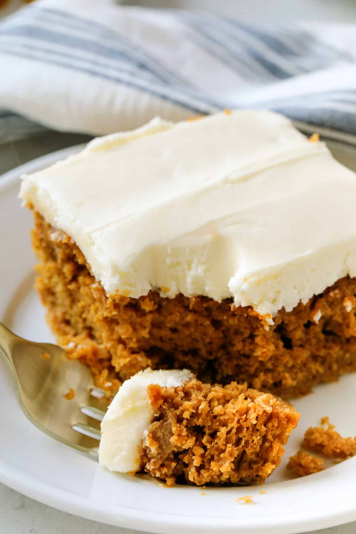 A piece of pumpkin cake with a bite out of it. 