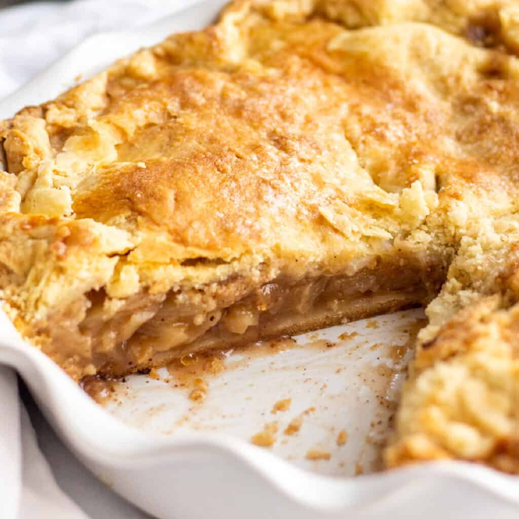 An apple pie with a slice missing.