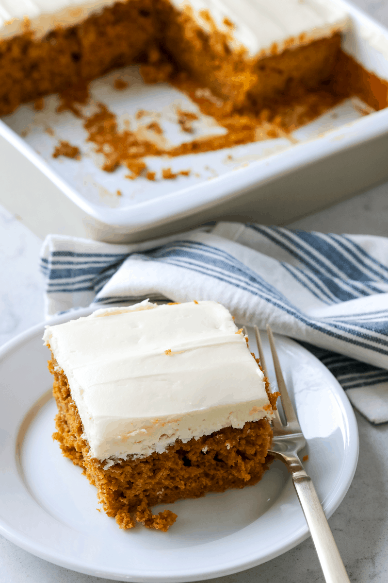 pumpkin cake with cream cheese frosting on a plate