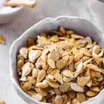 roasted pumpkin seeds served in a white bowl