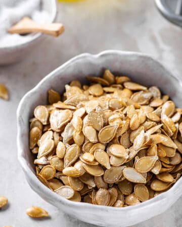 roasted pumpkin seeds served in a white bowl