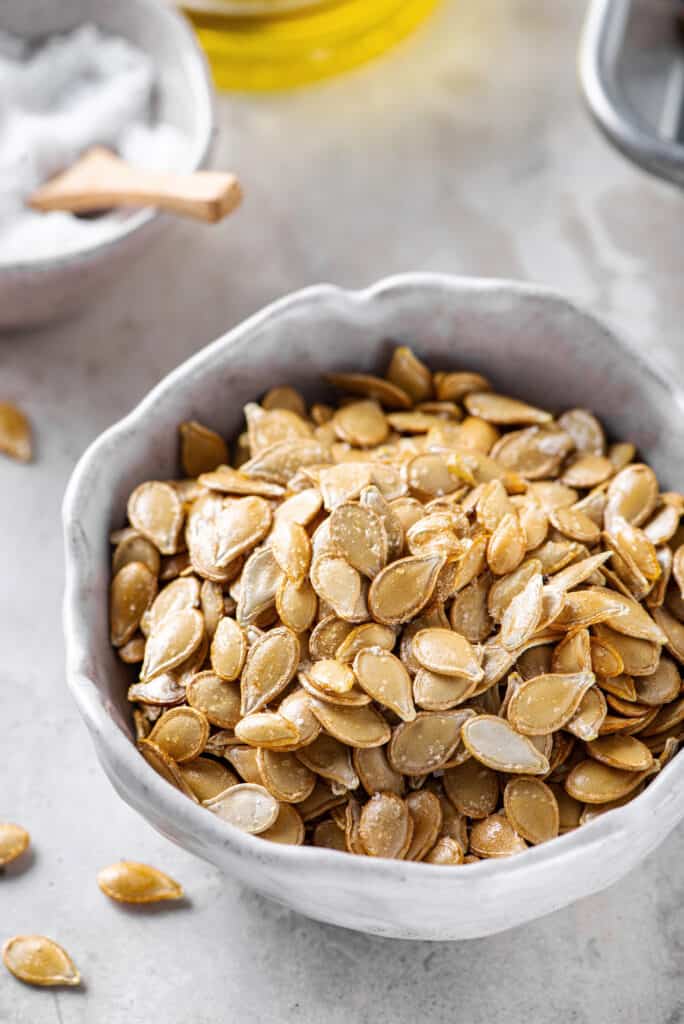 roasted pumpkin seeds served in a white bowl
