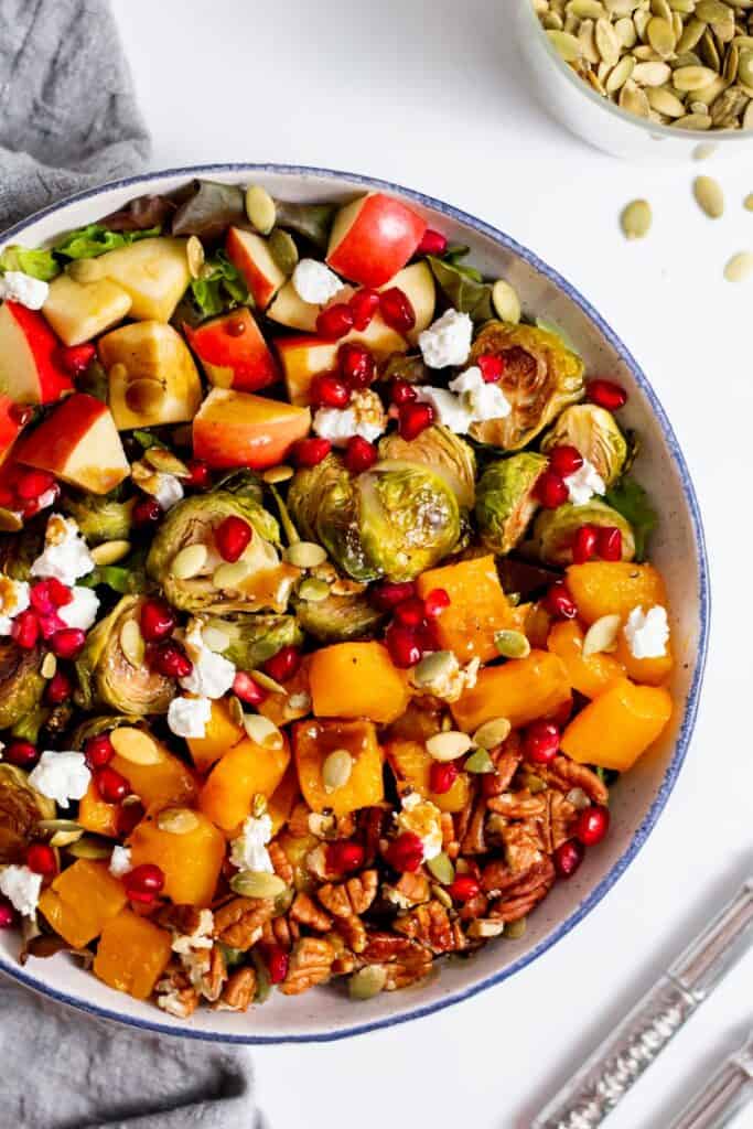 brussels sprouts salad served in a white bowl