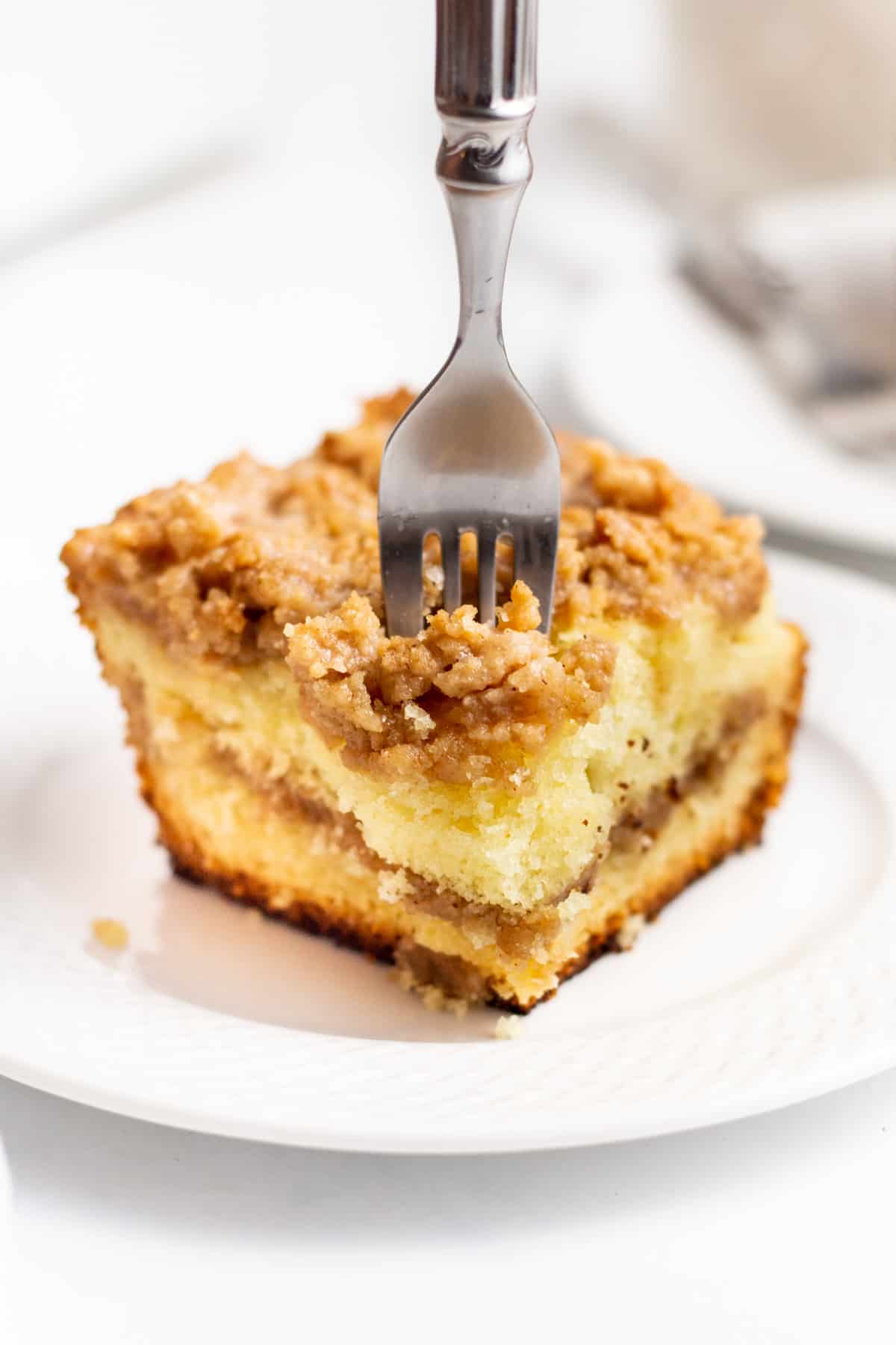 slice of sour cream cake mix coffee cake with a fork served on a plate