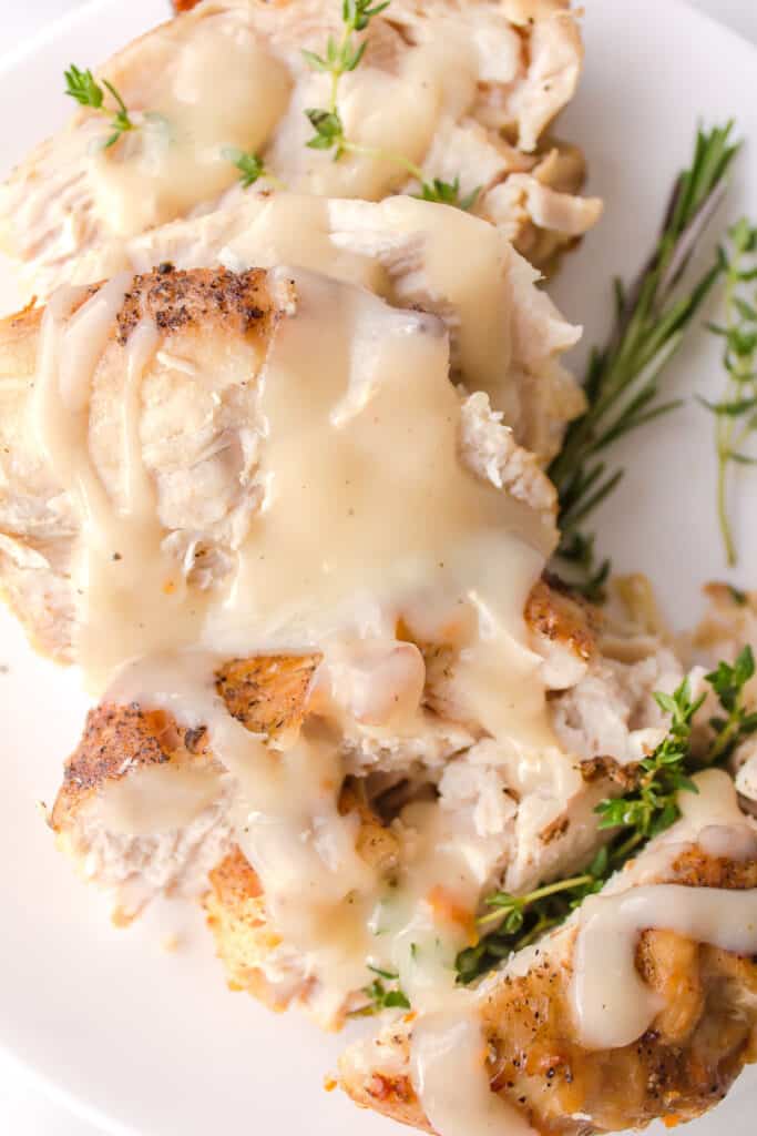 turkey gravy on turkey served on a plate