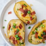 three twice baked potatoes on a white plate