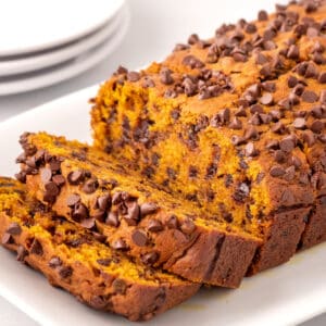 Chocolate chip pumpkin bread with two pieces sliced.
