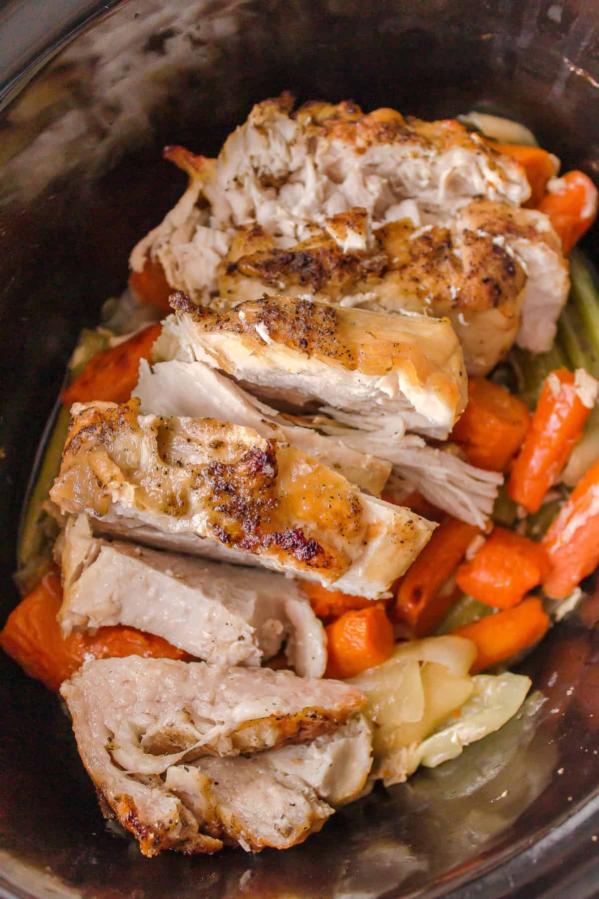 slow cooker turkey breast with carrots and celery in a slow cooker