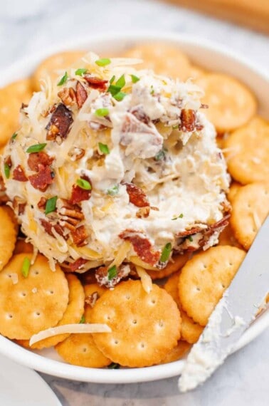 Cheese ball surrounded by Ritz crackers.