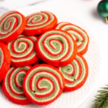 red white and green christmas pinwheel cookies on a plate