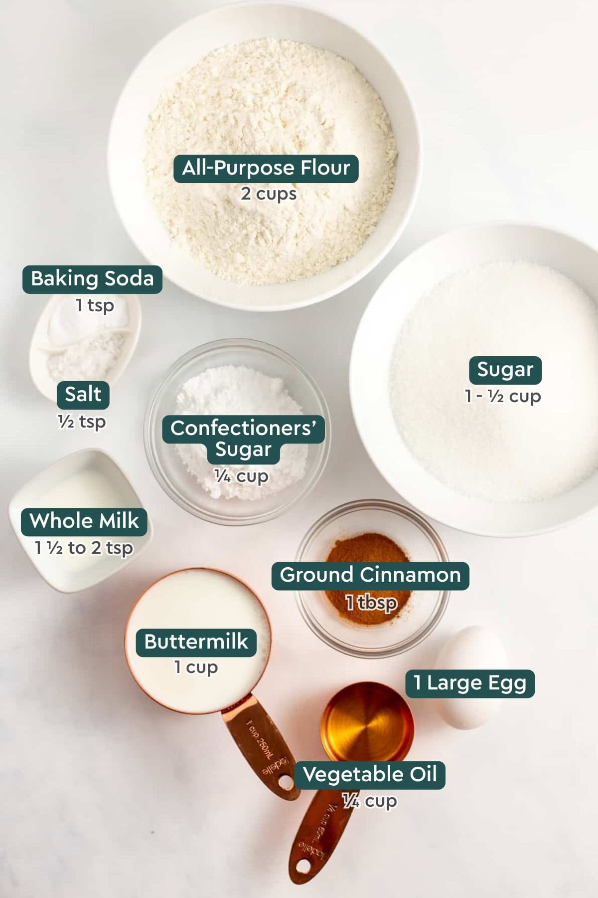 Ingredients for quick and easy cinnamon swirl bread, including flour, sugar, baking soda, salt, powdered sugar, milk, buttermilk, cinnamon, egg, oil.