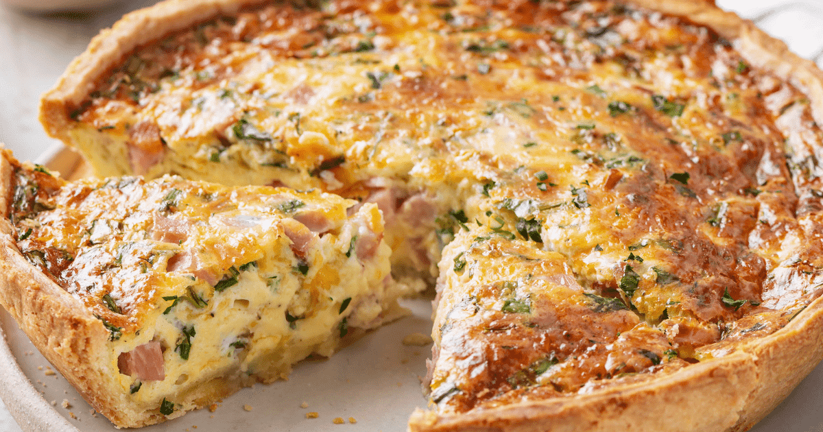 slice cut from ham and cheese quiche