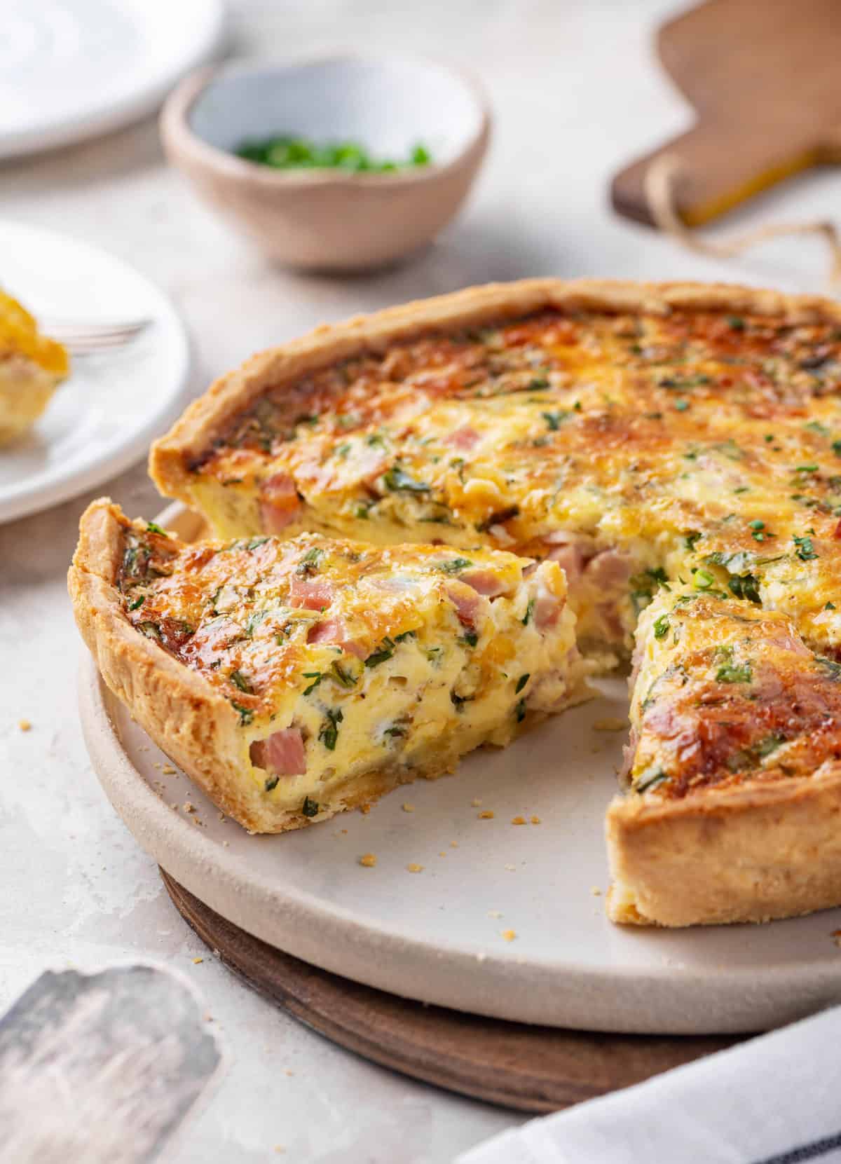 ham and cheese quiche on a ceramic plate