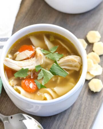 classic recipe for chicken noodle soup in a white bowl