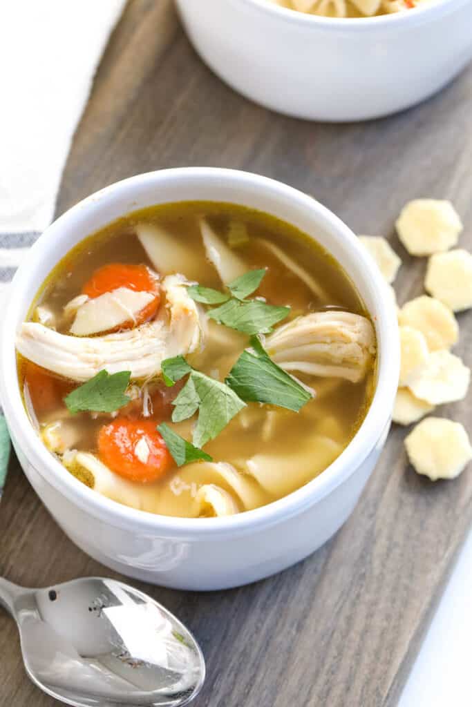 classic recipe for chicken noodle soup in a white bowl 