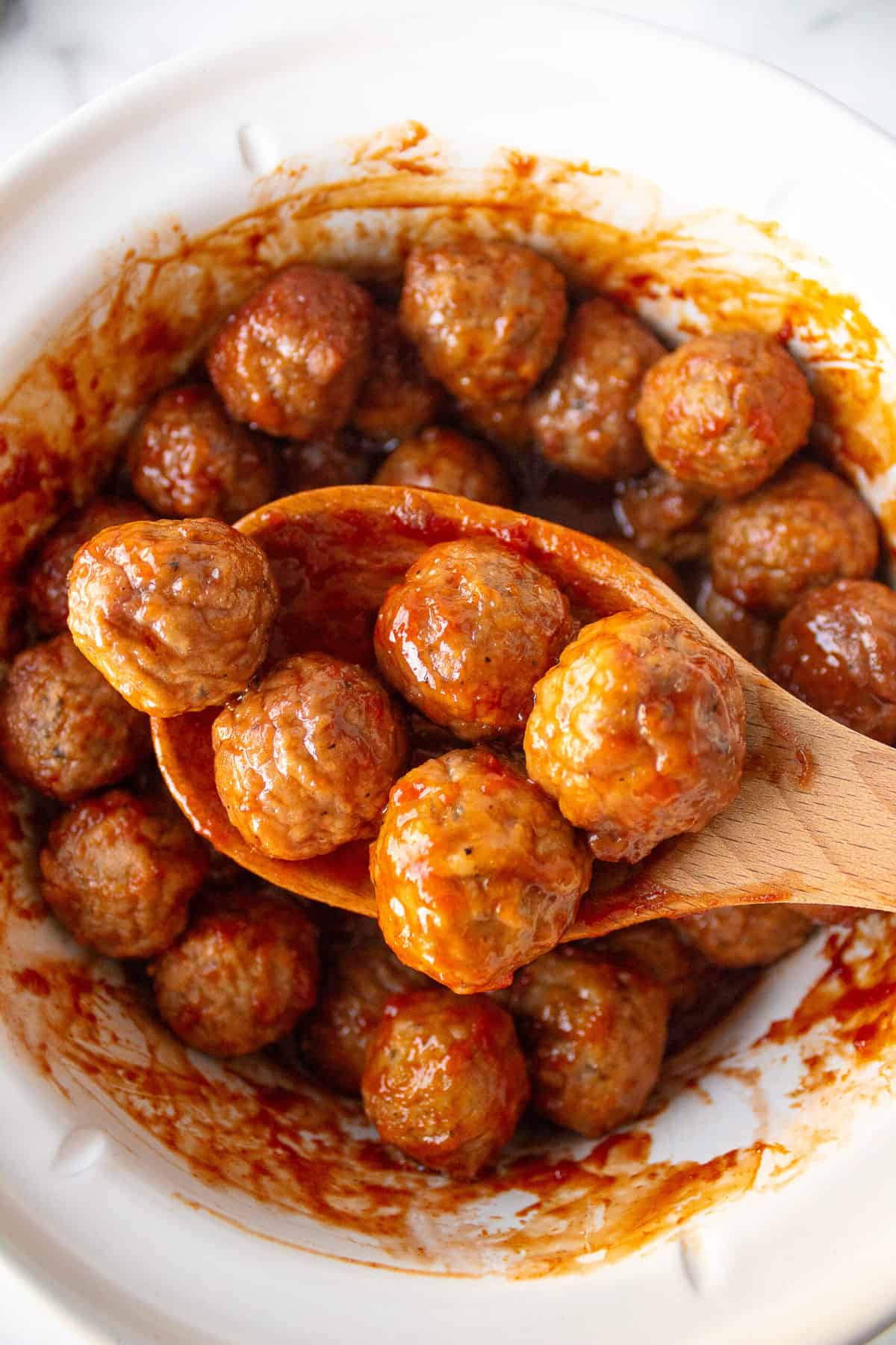 cocktail meatballs on a wooden spoon