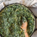 creamed spinach in a cast iron skillet pan