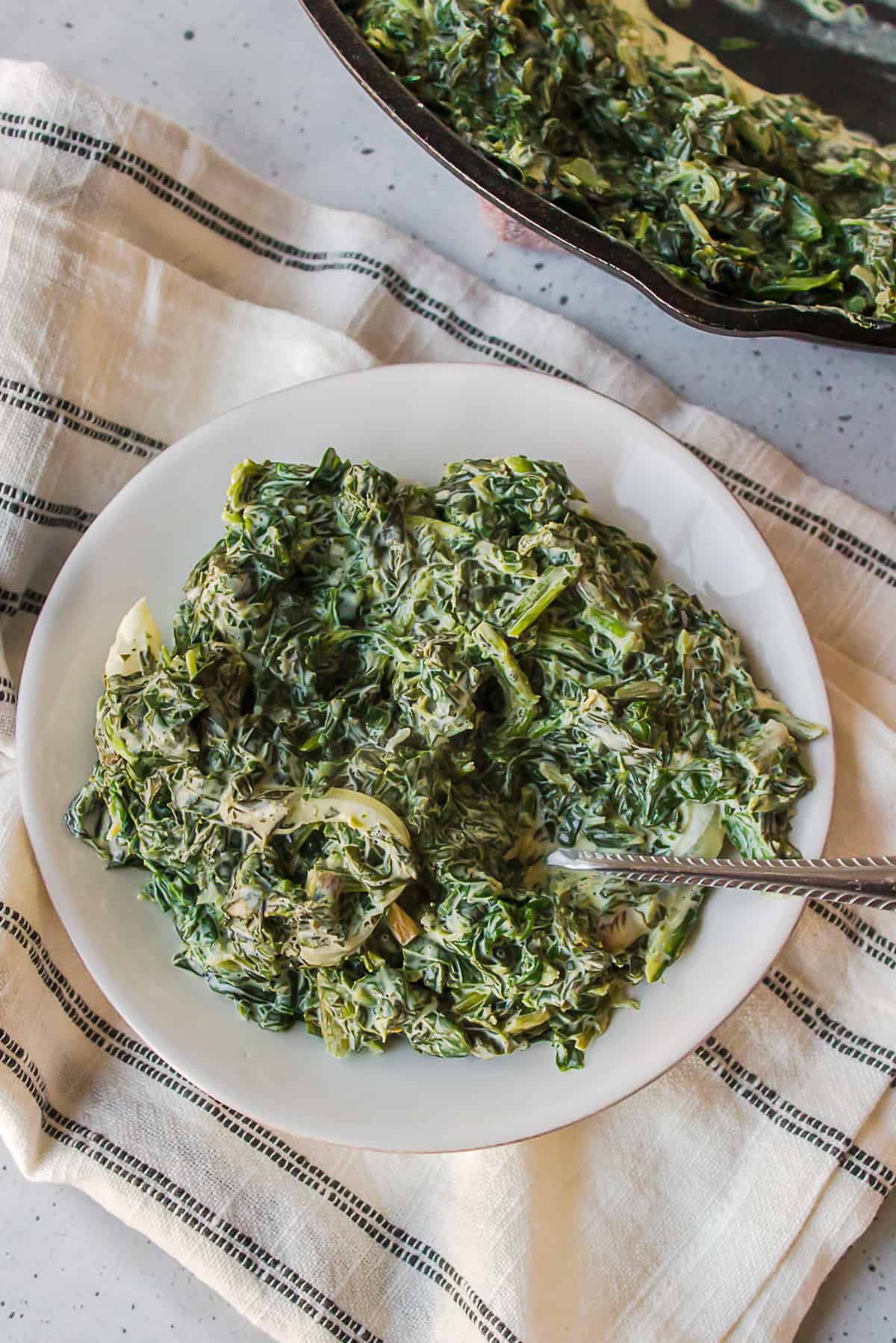 creamed spinach served on a round plate