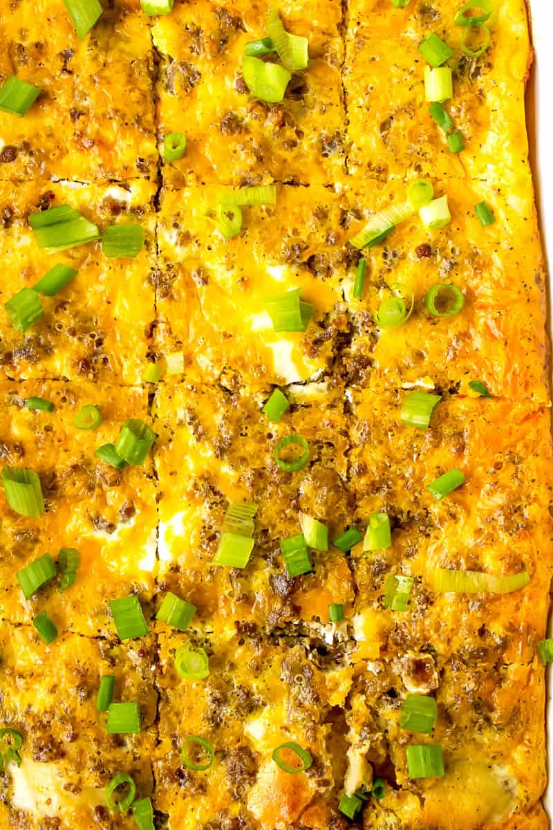 top view image of baked sausage breakfast casserole topped with chopped green onions