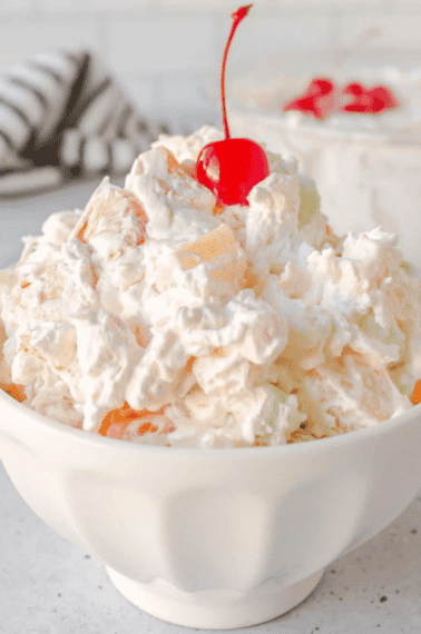 ambrosia salad served in an off white bowl