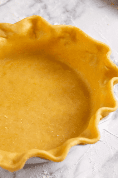 unbaked homemade pie crust in a pie dish