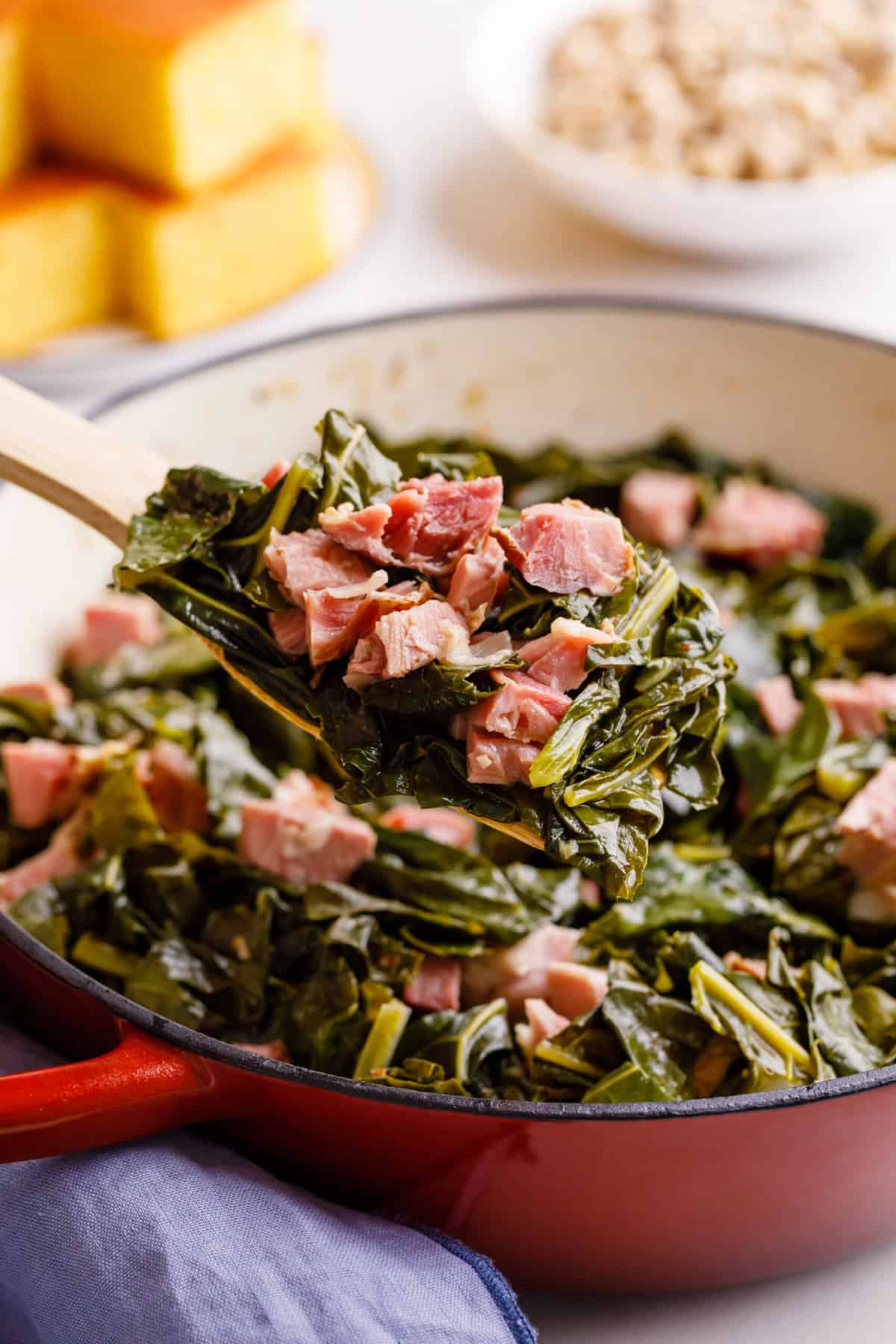 wooden spatula spoonful of collard green with ham