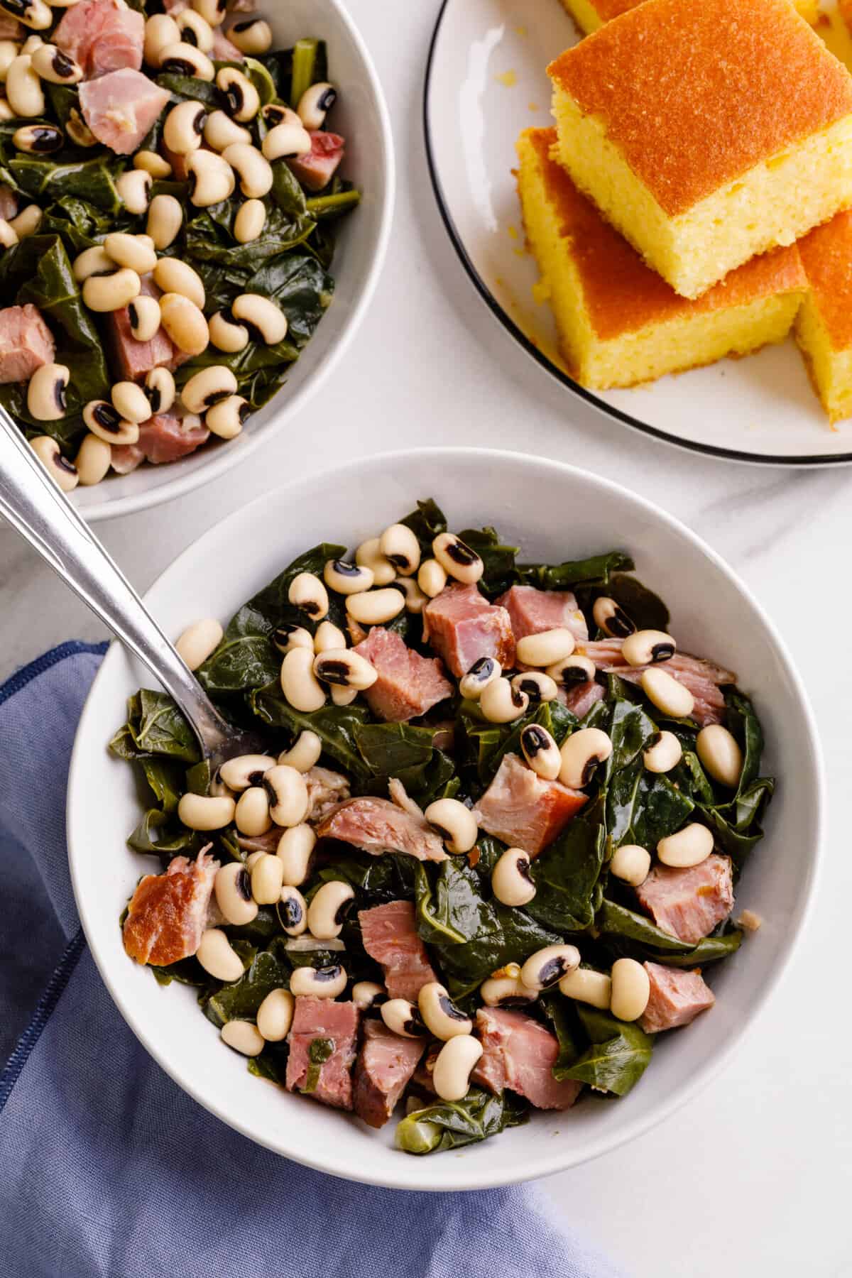 top down image of black-eyed peas with collard greens and ham