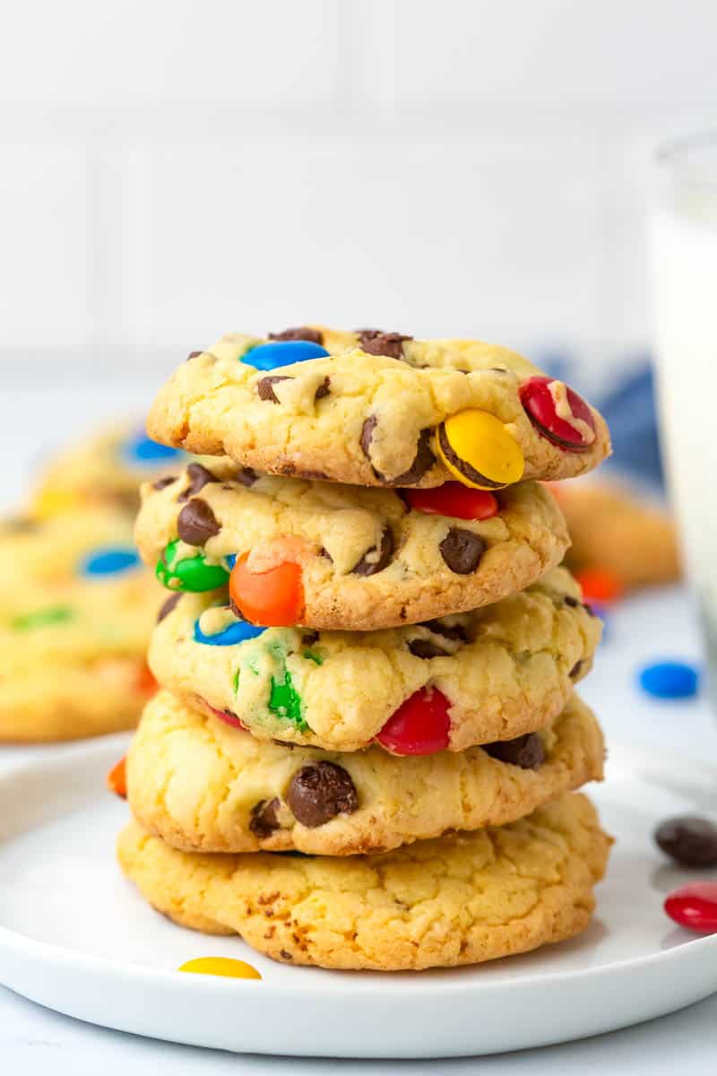 stacked cake mix m&m cookies on a white plate