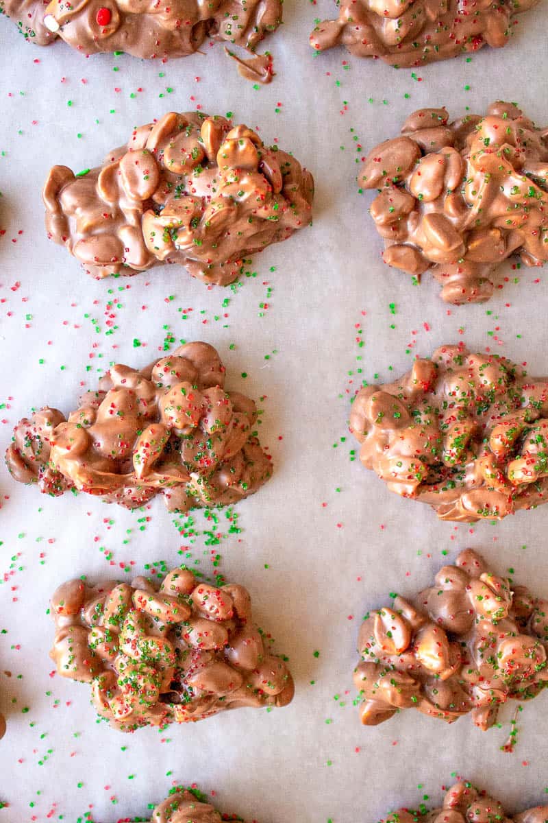 dollops of crock pot candy on a baking sheet with parchment paper