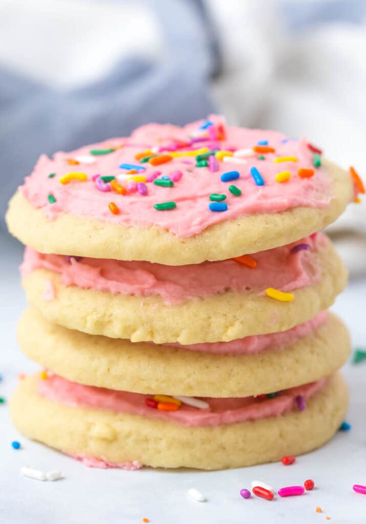 four stacked pink frosted sugar cookies