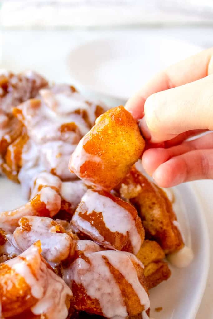 a piece of monkey bread being picked up from the table