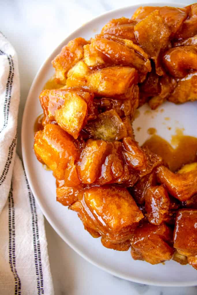 monkey bread on a white plate with a napkin