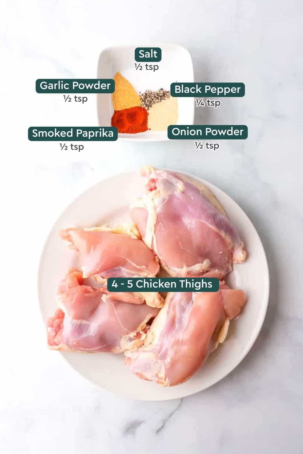 Ingredients for air fryer boneless skinless chicken thighs, including seasonings and chicken thighs.