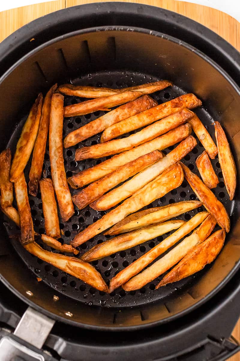 Homemade French fries in the air fryer basket.