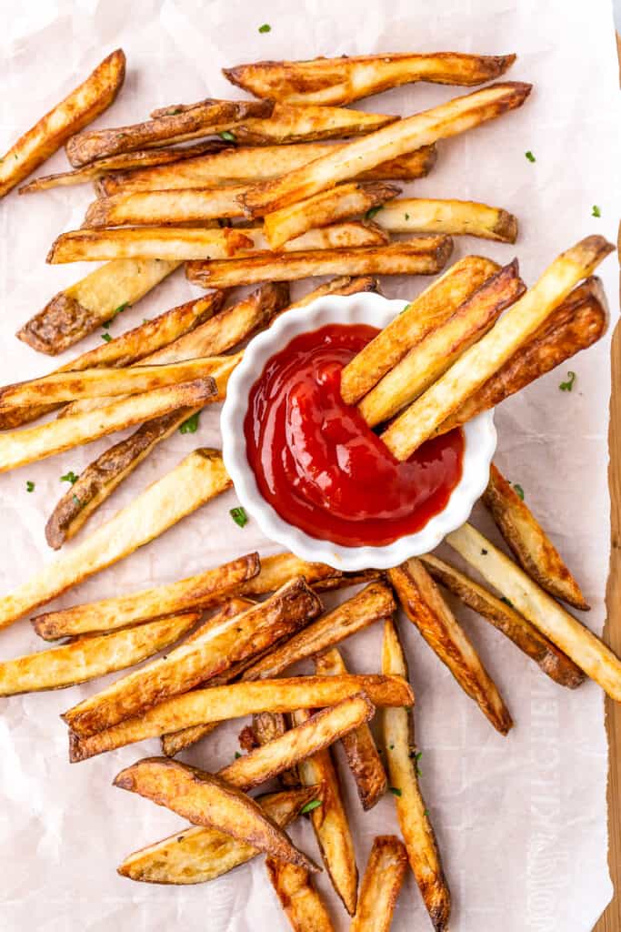dipping french fries into the ketchup