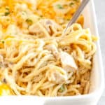 chicken tetrazzini in a casserole dish with a silver fork