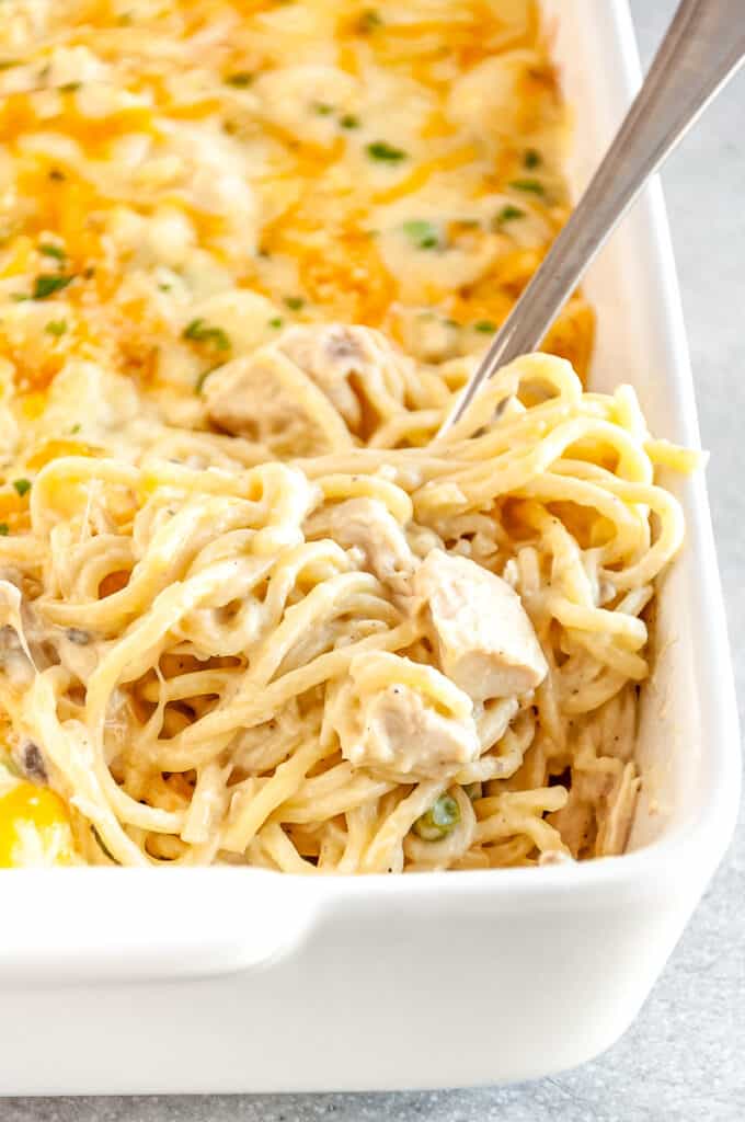 chicken tetrazzini in a casserole dish with a silver fork