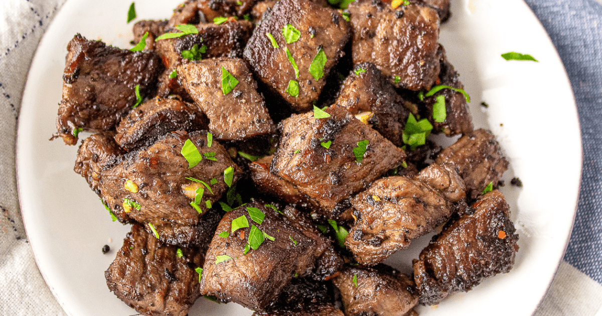 garlic butter steak bites on a white plate