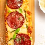 french bread pizza on a wooden platter