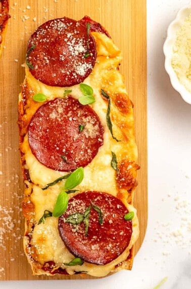 french bread pizza on a wooden platter