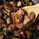 garlic butter steak bites on a wooden spoon