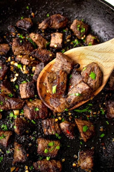 garlic butter steak bites on a wooden spoon