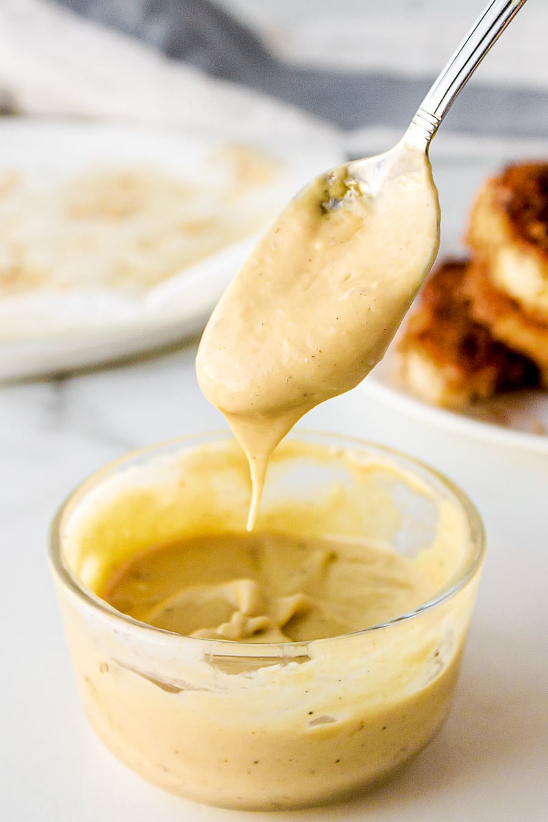 honey mustard sauce on a silver spoon