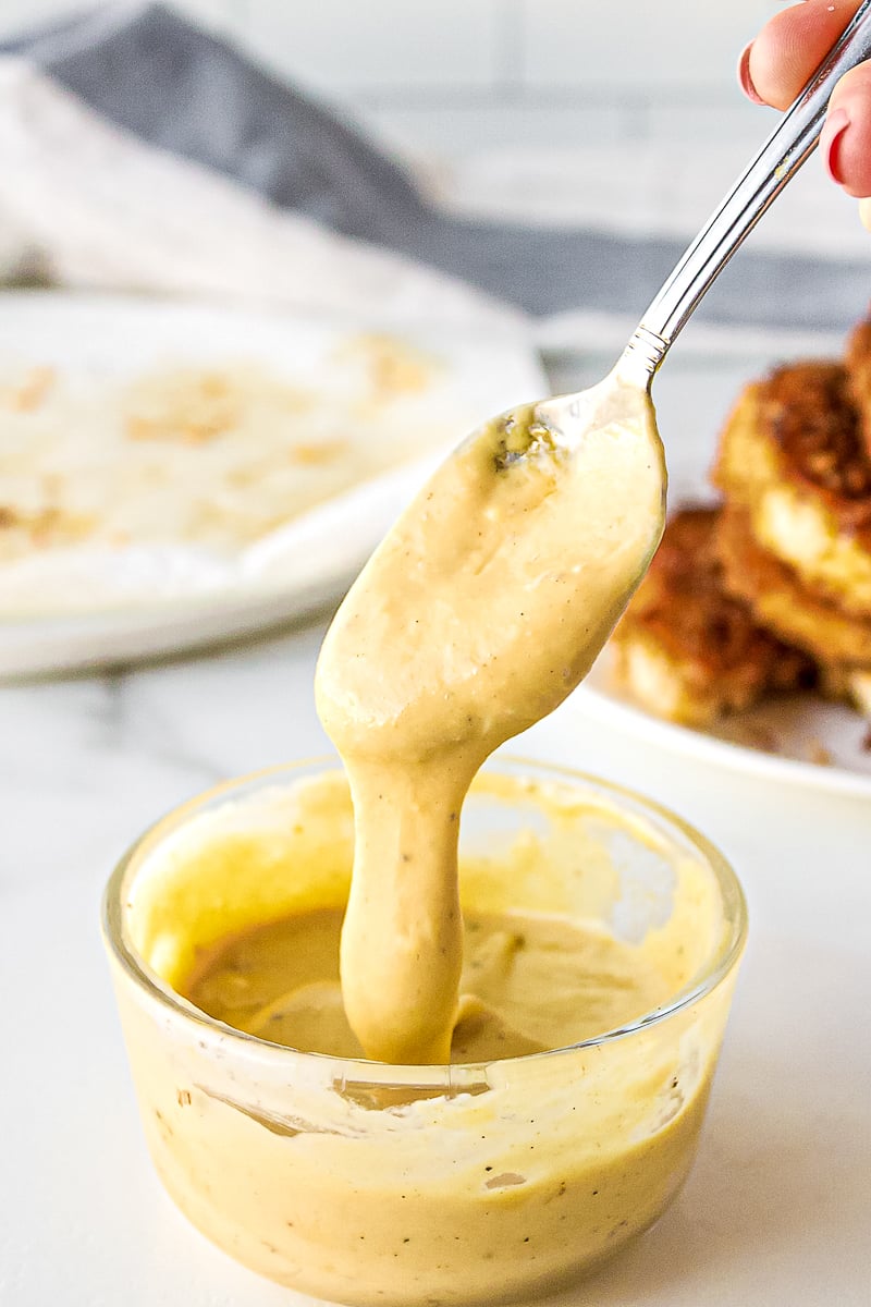 honey mustard dipping sauce on a silver spoon