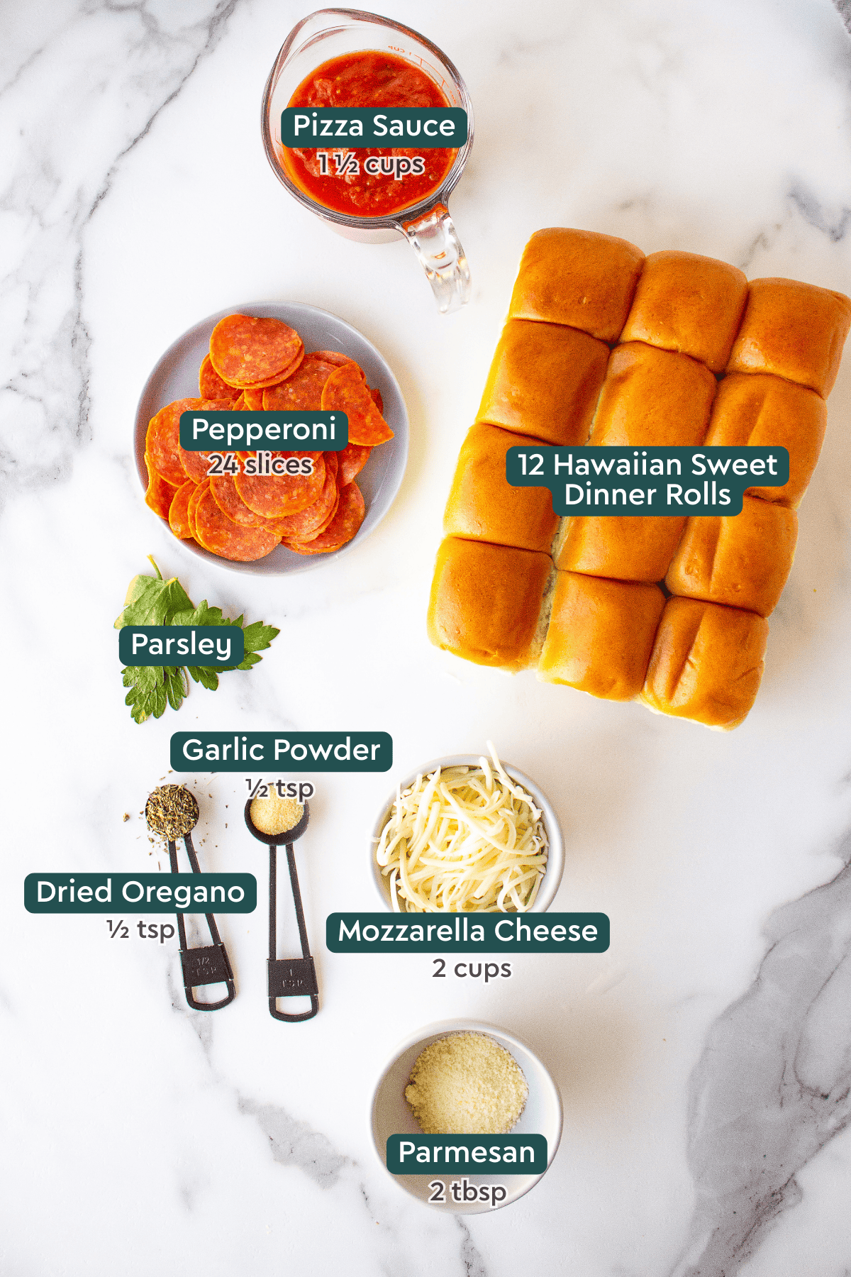 All of the ingredients for pizza sliders in bowls on a countertop. 
