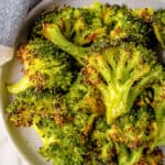 A plate full of roasted frozen broccoli.