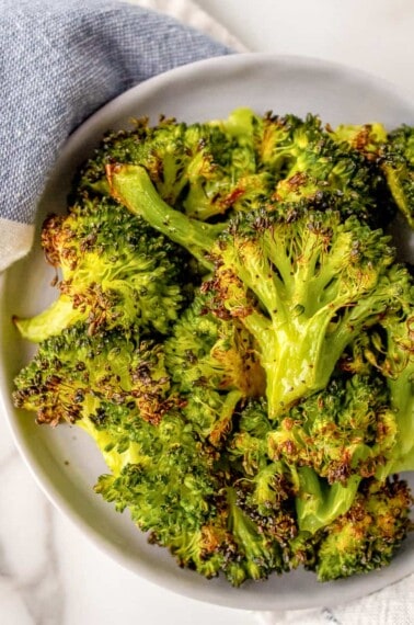 A plate full of roasted frozen broccoli.