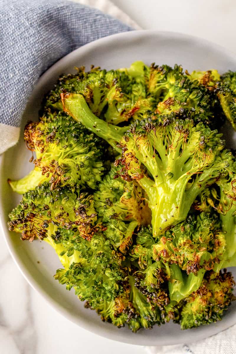 roasted broccoli served on a white plate