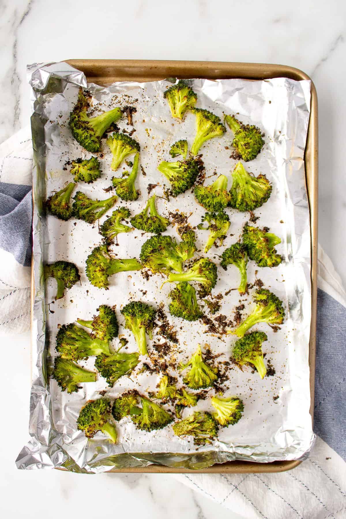 Roasted Broccoli on a baking sheet lined with foil